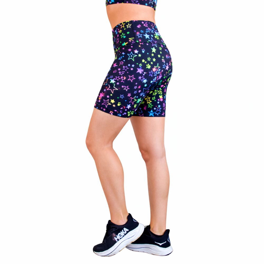 fitness shorts in a black base with multi-colour stars on a women