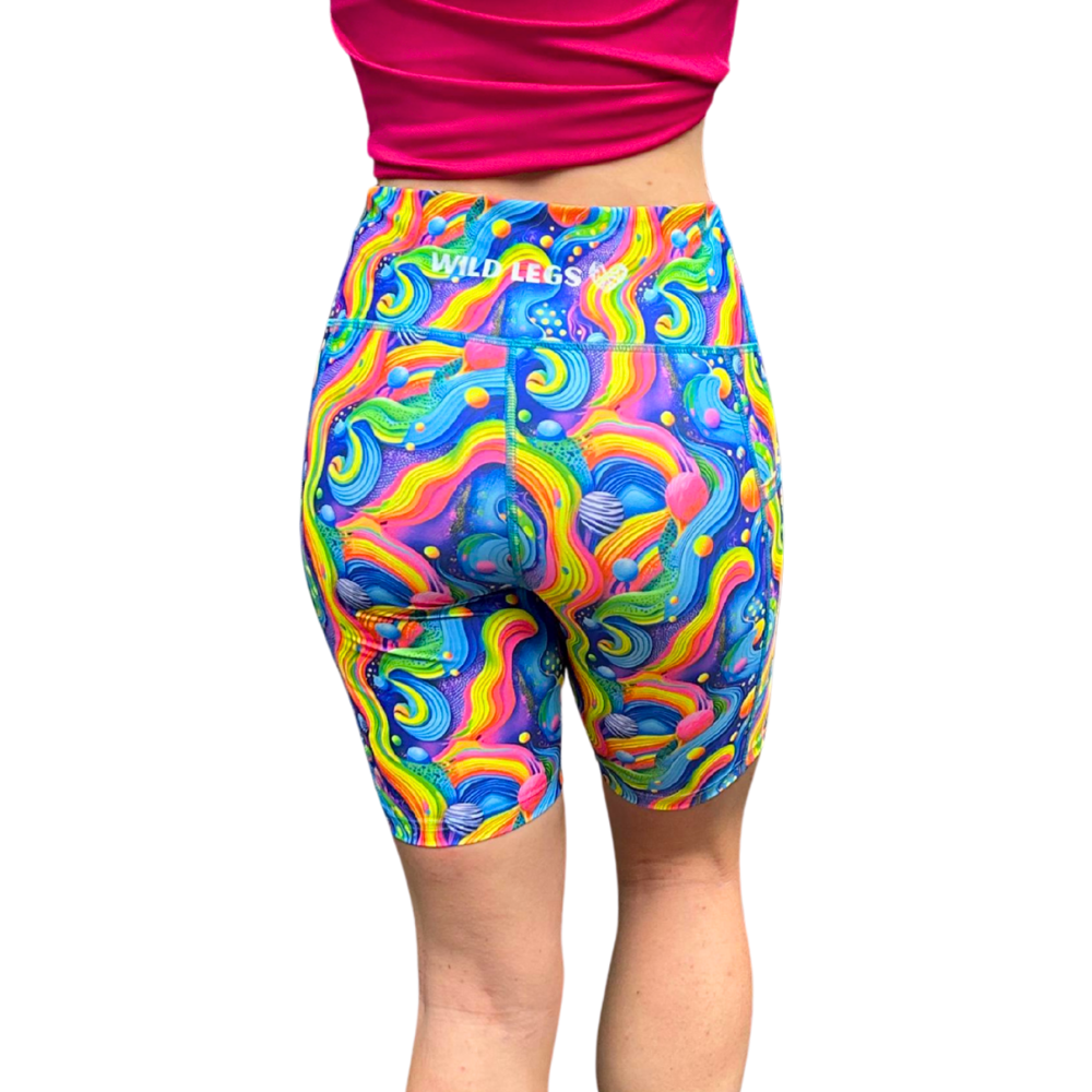 Colourful rainbow fitness shorts showing the Wild Legs Logo on the waistband rear view on a white background