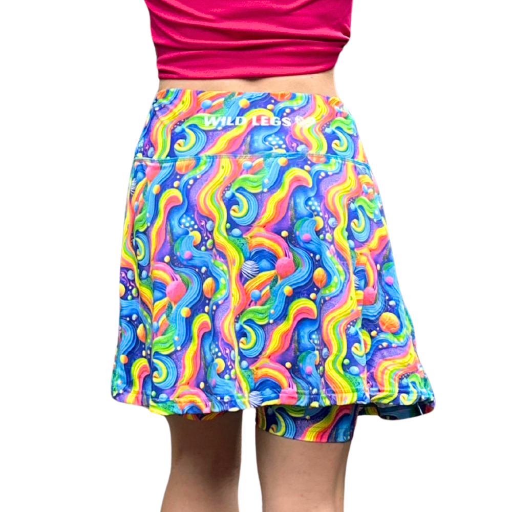 Bright Rainbow Coloured skort showing the Wild Legs logo on rear waistband on a white background