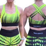 Neon yellow and black sports bra and leggings set with 'Wild Legs' branding.