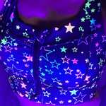 Neon star-patterned sports bra under black light
