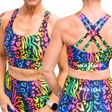 Multicolored animal print sports bra and leggings set with 'Wild Legs' branding.