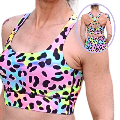 Multicolored leopard print sports bra on a person, with an inset showing the back design.