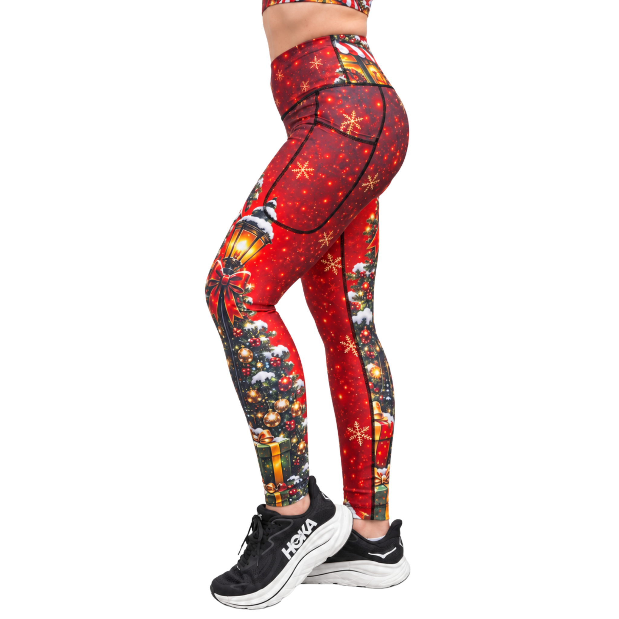 Red Christmas Fitness Leggings shown from the side with Candy Canes, Christmas shop fronts, snow flakes, lanterns and snowy tress with black shoes on a white background