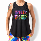 Person wearing a black tank top with 'WILD INSIDE' text and colorful leggings on a white background