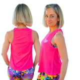 Woman wearing a bright pink sleeveless top with a logo and colorful tie-dye leggings, shown from front and back.