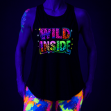 Person wearing a black tank top with 'WILD INSIDE' text and colorful pants under black light.