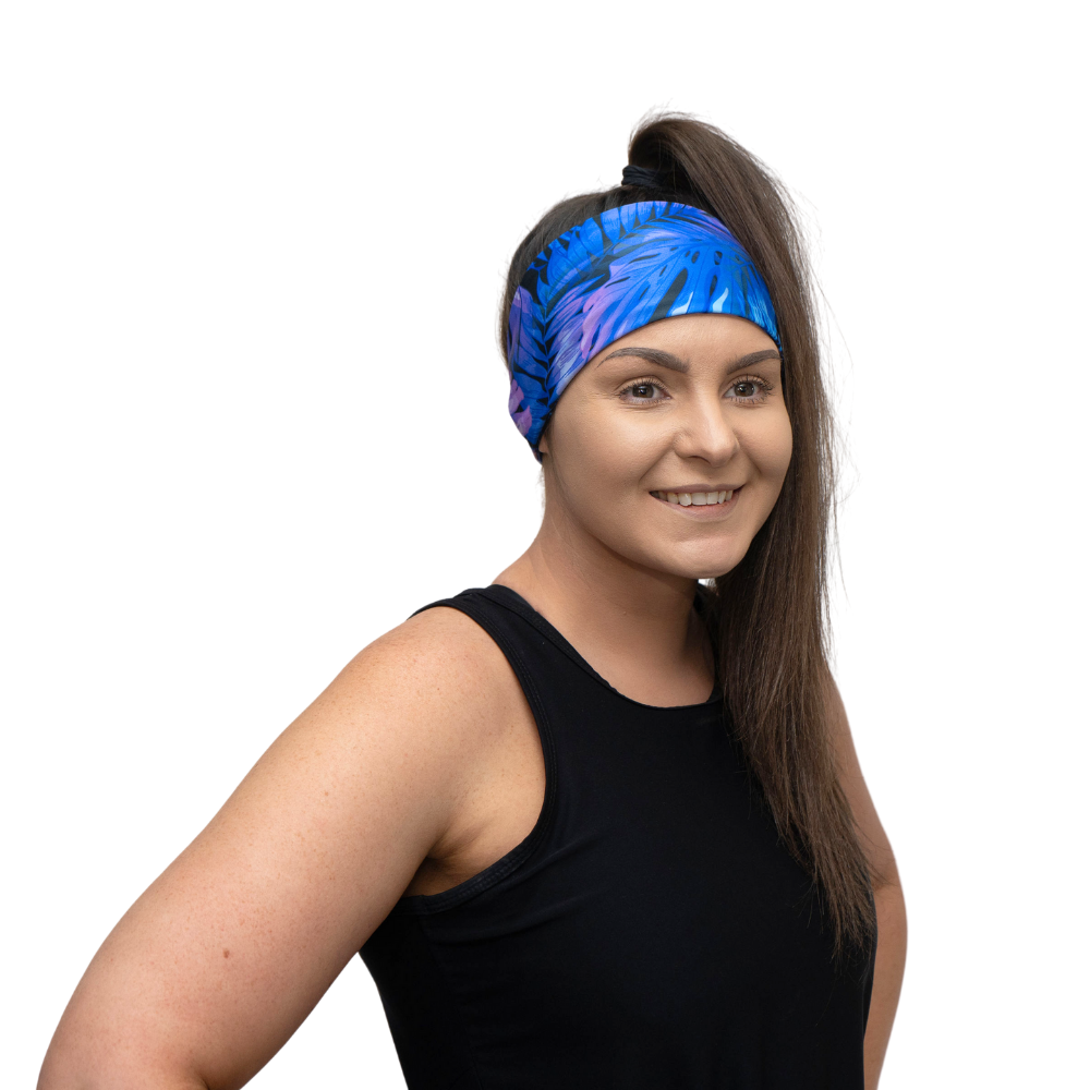 woman wearing blue and purple tropical design headband on a white background