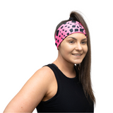 woman in bright pink and black headband on a white background