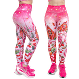 Pink Christmas-themed leggings shown from the back and front on a model, featuring a candy cane, gingerbread house, and candy print, paired with pink shoes