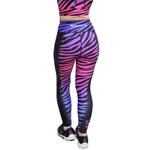 Zebra print leggings with a gradient of purple and pink on a white background