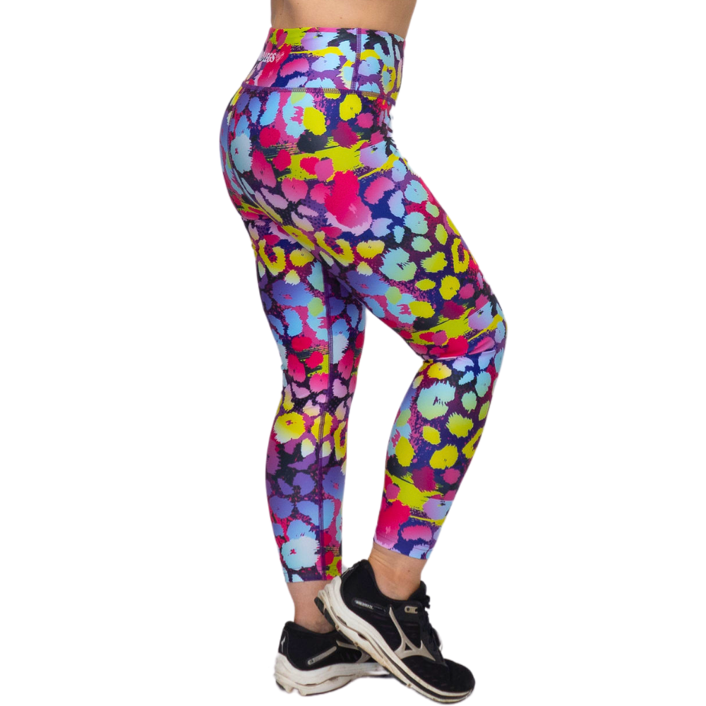 Colorful patterned leggings worn by a person on a white background