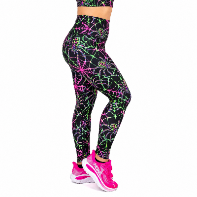 A person wearing high-waisted leggings with a black base and a neon pink, green, and yellow spiderweb pattern, paired with bright pink trainers, shown from the waist down on a white background.