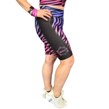 Person wearing black and pink zebra pattern shorts on a white background