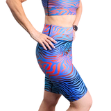 Person wearing a blue and orange patterned athletic outfit on a white background