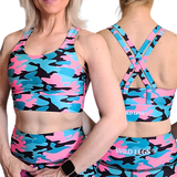 Woman wearing a colorful camouflage sports bra and shorts set with 'Wild Legs' branding.