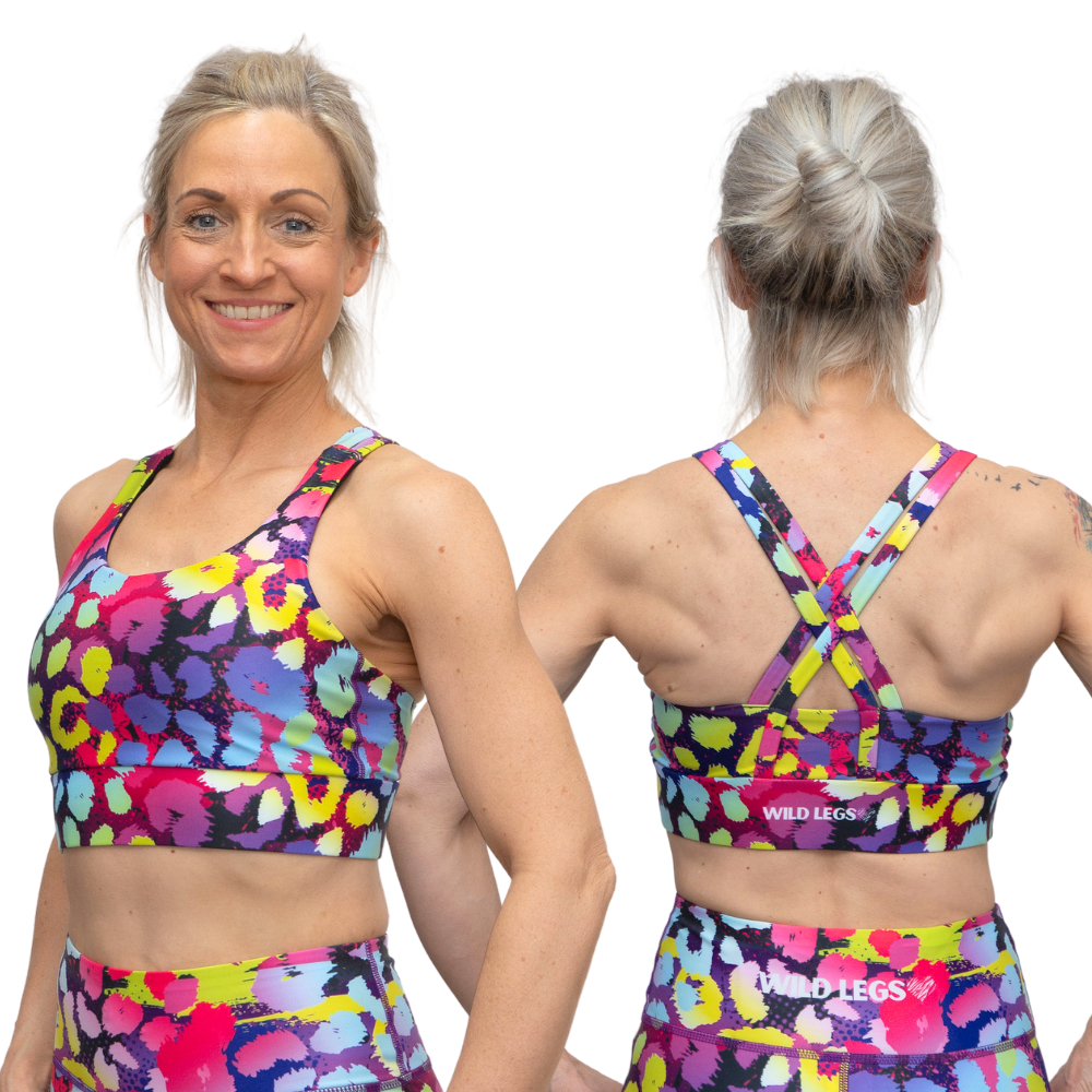 woman wearing a bright coloured, animal print sports bra showing the front and back on a white background