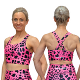 woman wearing pink and black patterned sports bra showing front and back view with Wild Legs branding