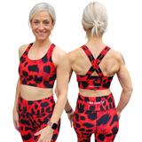 woman wearing red and black animal print design sports bra, shown from the front and the back